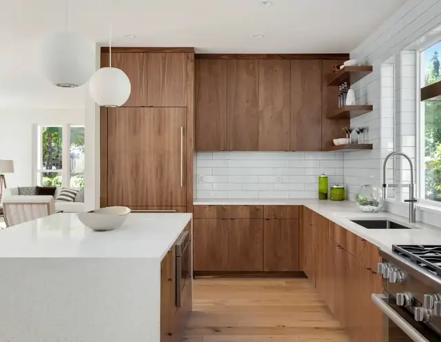 Jupiter kitchen with walnut slab cabinets, integrated refrigerator panels, white quartz waterfall island and globe pendants