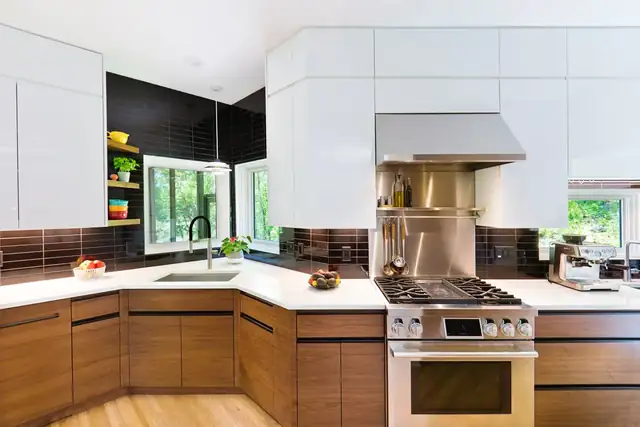 Modern Jupiter interior with white upper cabinets, walnut lower cabinets, dark glass tile backsplash and stainless range hood
